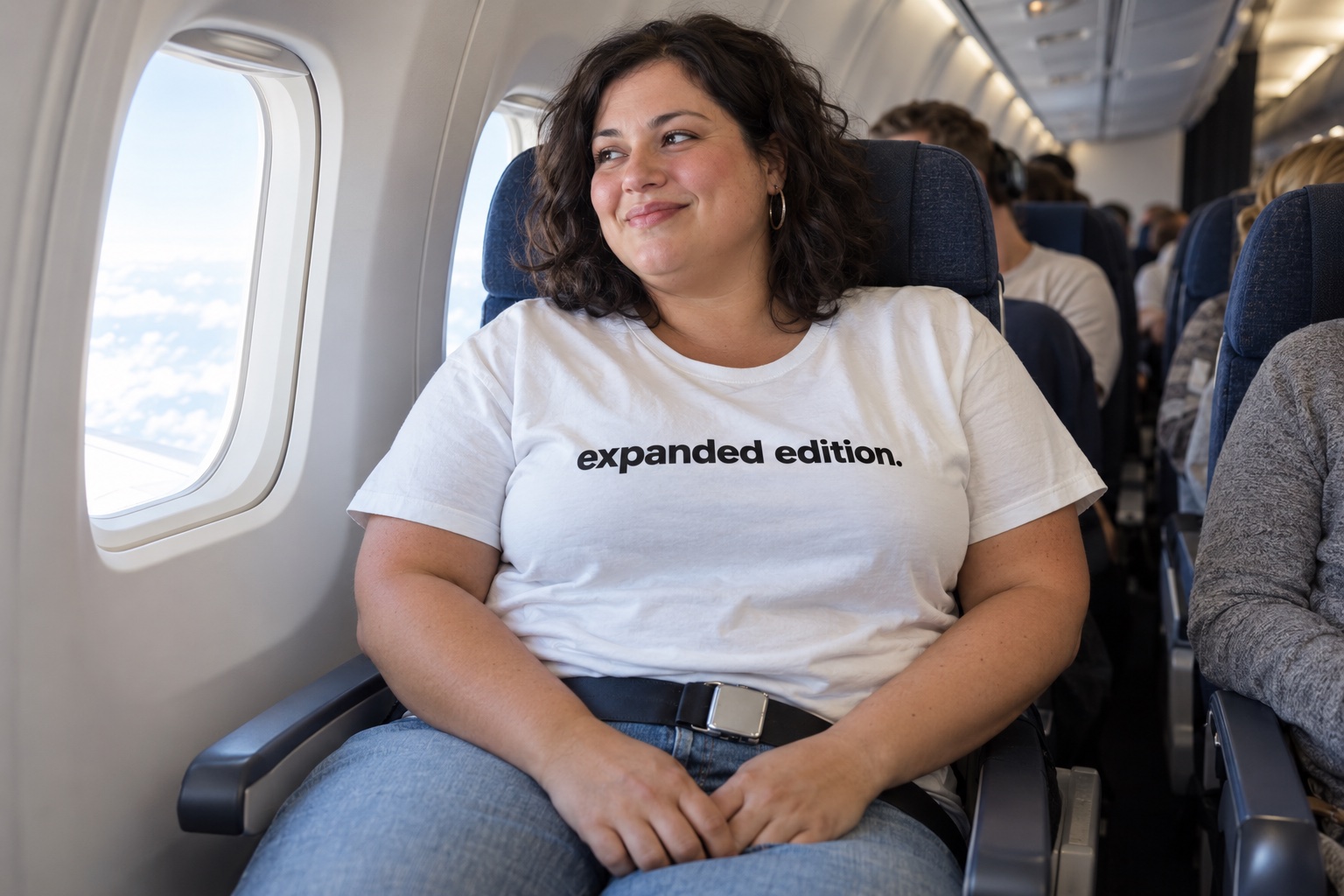 AI-generated lifestyle scene of a plus-size woman in an airplane window seat wearing the expanded edition. shirt.